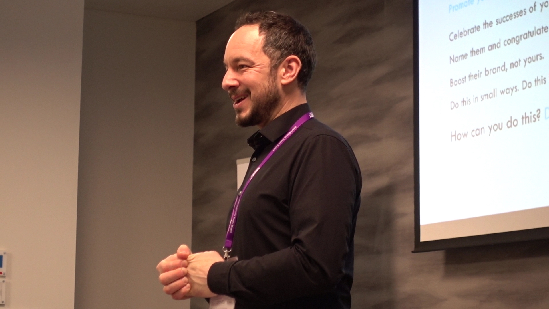 Richard Bradford of Disquiet Dog Marketing consultancy smiling as he looks at the audience out of view.