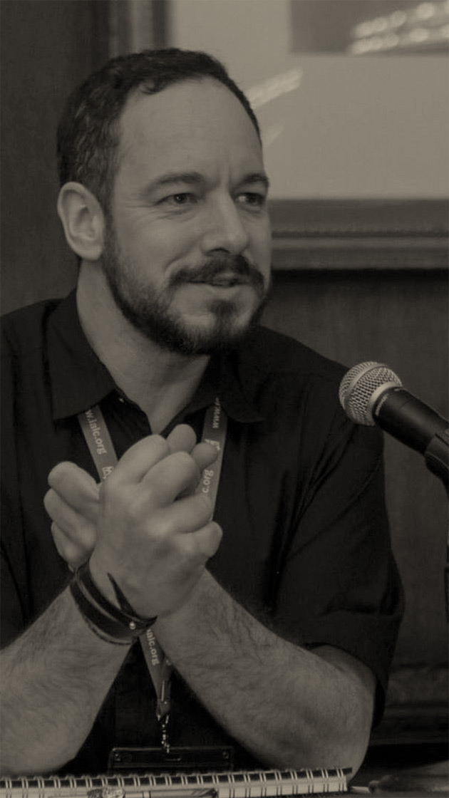 Richard Bradford, Managing Director of Disquiet Dog, seated in front of a microphone on an expert panel discussion.